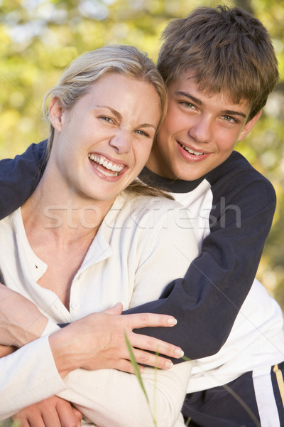 Woman and young boy embracing outdoors and smiling Stock photo © monkey_business