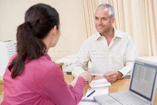 Doctor with laptop and man in doctor's office smiling Stock photo © monkey_business