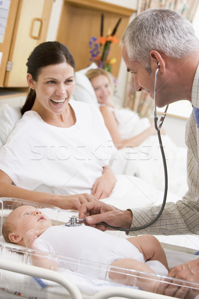 Doctor checking baby's heartbeat with new mother watching and sm Stock photo © monkey_business