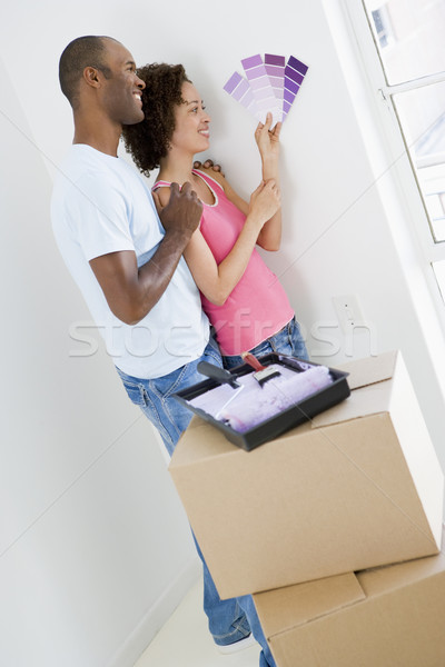Couple with paint swatches in new home smiling Stock photo © monkey_business