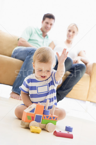 Couple in living room with baby smiling Stock photo © monkey_business