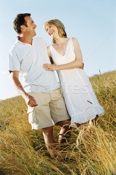 Pareja pie aire libre sonriendo mujer hombre Foto stock © monkey_business