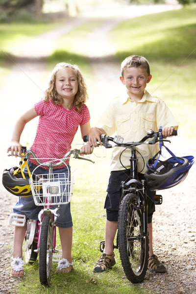 Stock photo: Children riding bikes in countryside