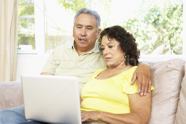 [[stock_photo]]: Couple · de · personnes · âgées · utilisant · un · ordinateur · portable · maison · internet · homme · portable