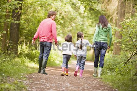 Mother and children walking along woodland path Stock photo © monkey_business