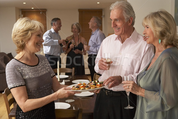 Nő adag vacsora vendégekkel étel nők boldog Stock fotó © monkey_business
