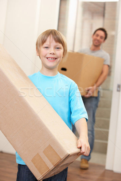 Boy with young man on moving day carrying cardboard box Stock photo © monkey_business