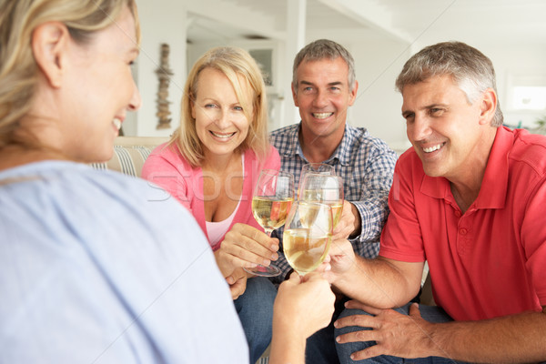 Mid age couples drinking together at home Stock photo © monkey_business