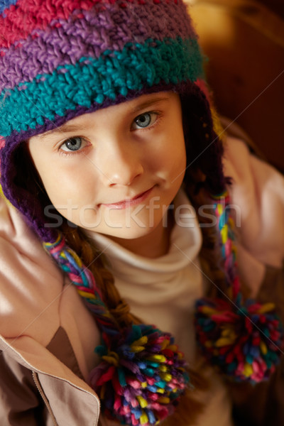 Young Girl Sitting On Wooden Seat Wearing Warm Outdoor Clothes Stock photo © monkey_business