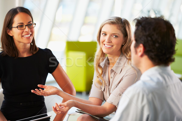 Businesspeople Having Meeting Around Table In Modern Office Stock photo © monkey_business