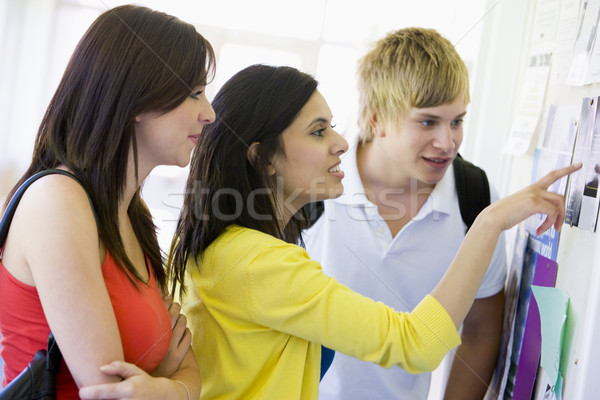 Stock photo: College students looking at a bulletin board