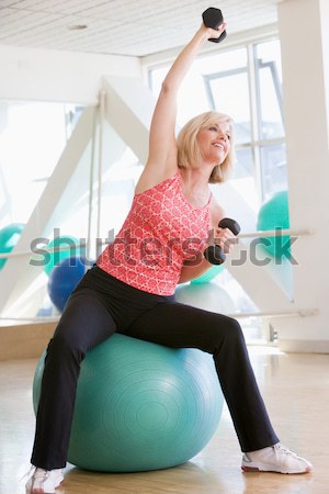 Stock photo: Woman Stretching On Swiss Ball At Gym