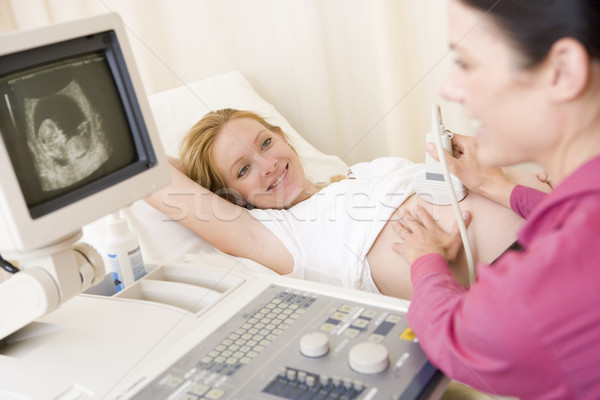 Stock photo: Pregnant woman getting ultrasound from doctor