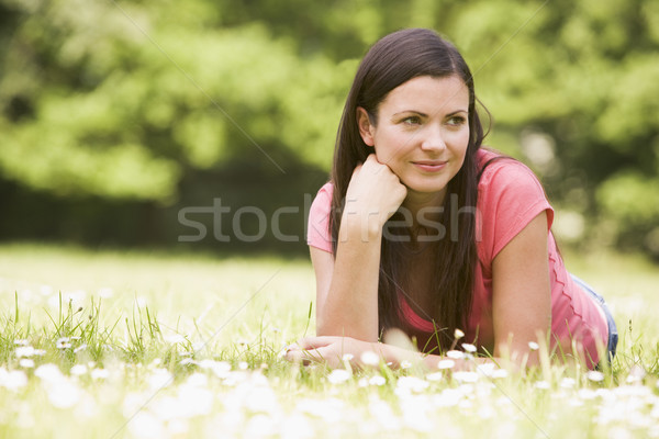 Stock photo: Woman lying outdoors smiling