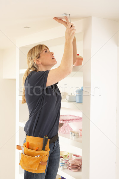 Female Electrician Installing Light Fitting In Home Stock photo © monkey_business