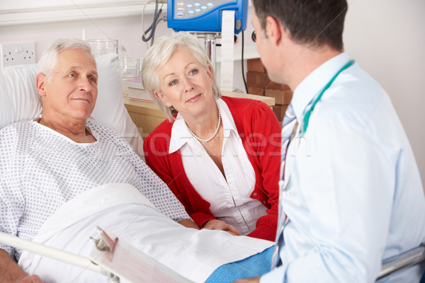 Doctor talking to senior couple on UK Hospital ward Stock photo © monkey_business