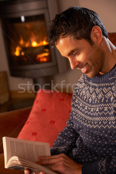 Middle Aged Man Relaxing With Book By Cosy Log Fire Stock photo © monkey_business