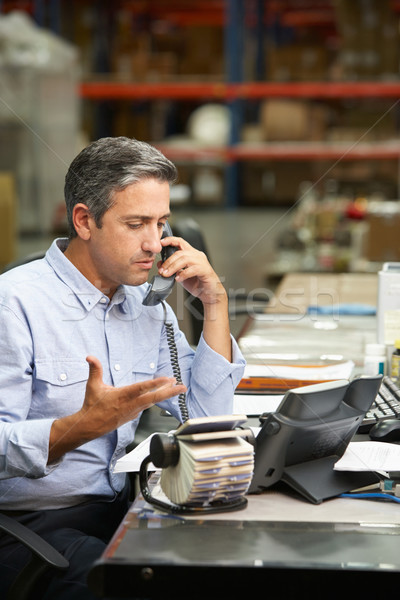 Manager Working At Desk In Warehouse Stock photo © monkey_business