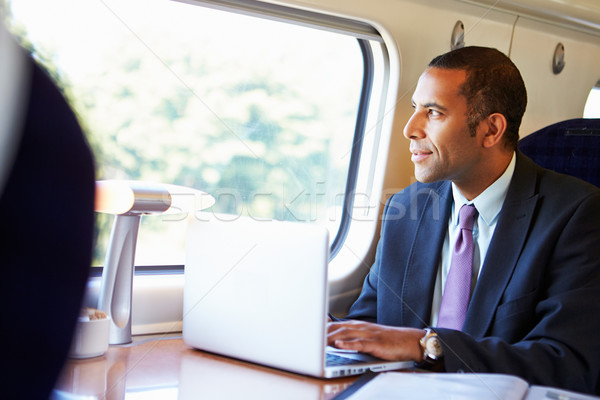 üzletember ingázás munka vonat laptopot használ férfi Stock fotó © monkey_business