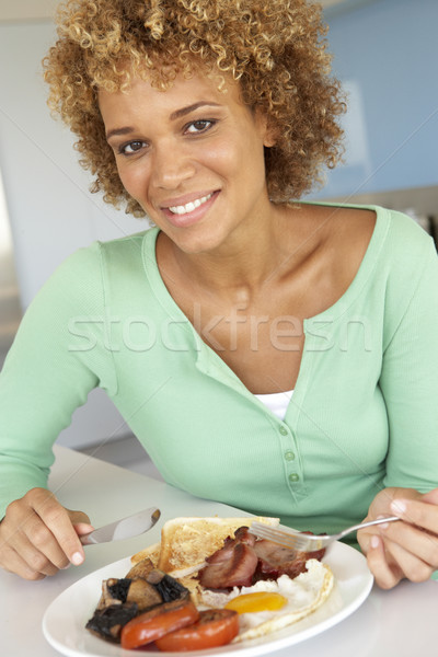 Mid Adult Woman Eating Unhealthy Fried Breakfast Stock photo © monkey_business