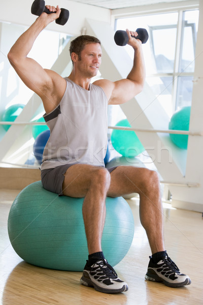 Man Using Hand Weights On Swiss Ball At Gym Stock photo © monkey_business