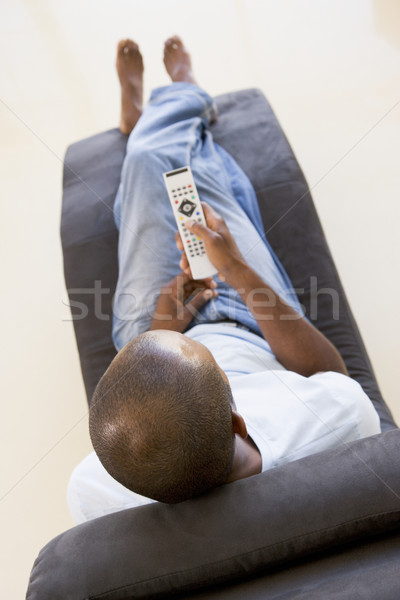 Homme séance président télécommande Homme flou [[stock_photo]] © monkey_business