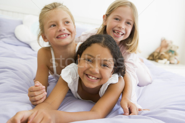 Three Young Girls Lying On Top Of Each Other In Their Pajamas Stock photo © monkey_business