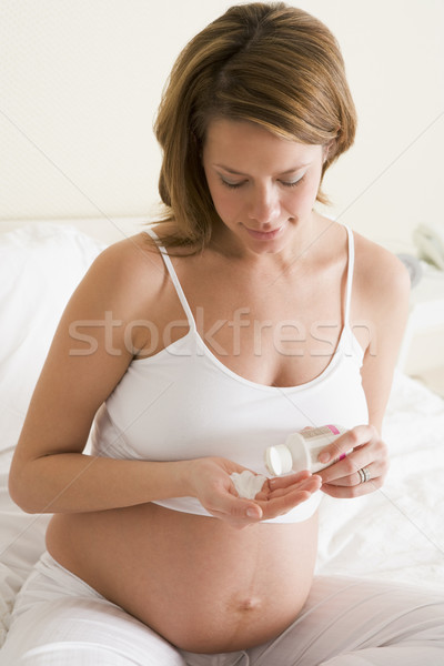 Pregnant woman in bedroom with medicine Stock photo © monkey_business