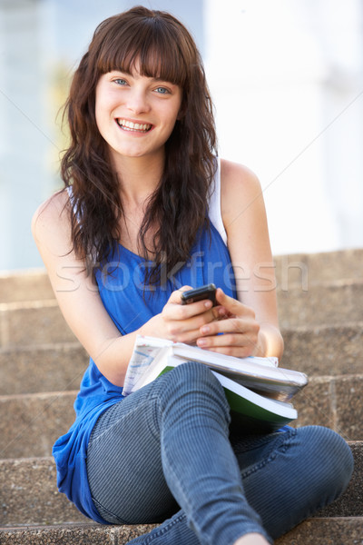 Teenage Student Sitting Outside On College Steps Using Mobile Ph Stock photo © monkey_business
