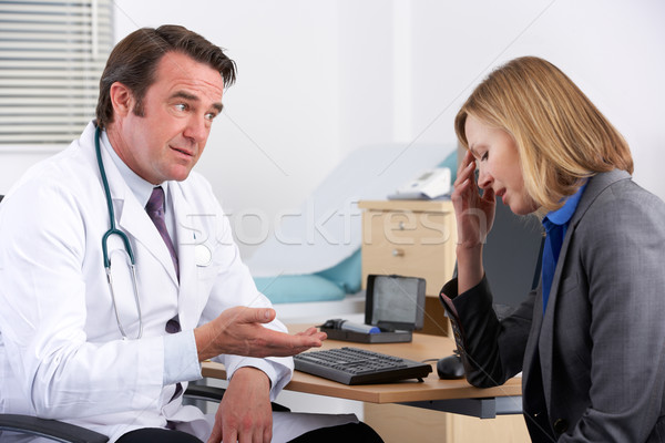 American doctor talking to depressed businesswoman Stock photo © monkey_business