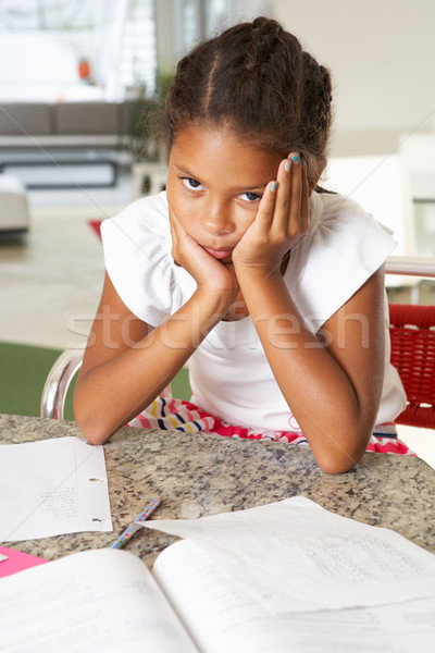 Fed Up Girl Doing Homework In Kitchen Stock photo © monkey_business