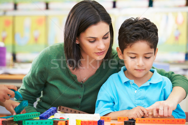 Stock photo: Elementary Pupil Counting With Teacher In Classroom