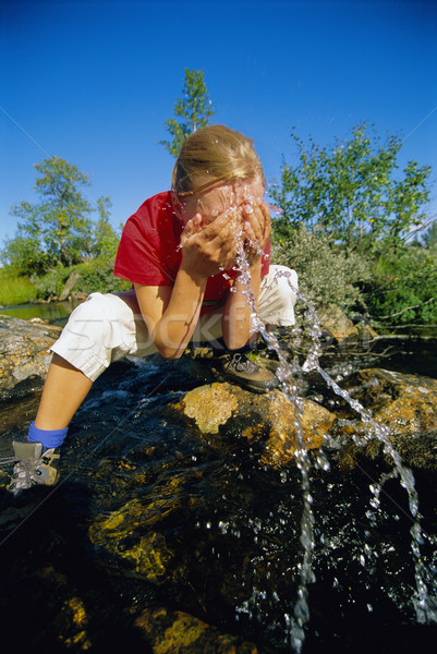 Young woman washing her face in river Stock photo © monkey_business