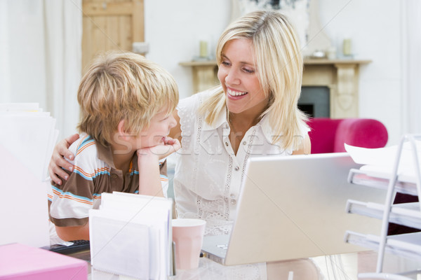Stock photo: Woman and young boy in home office with laptop smiling