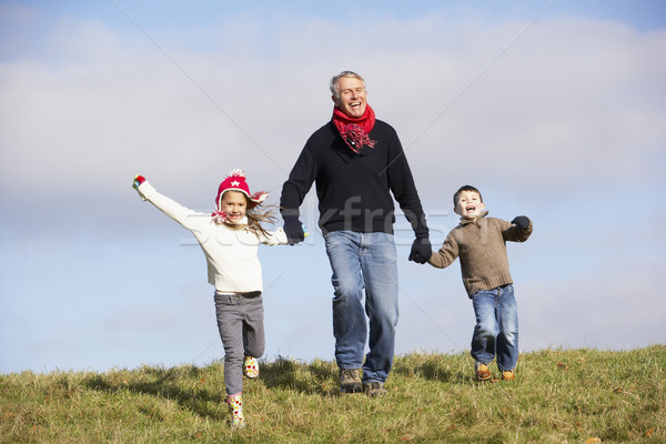 Grand-père mains tenant petits enfants homme hiver courir [[stock_photo]] © monkey_business