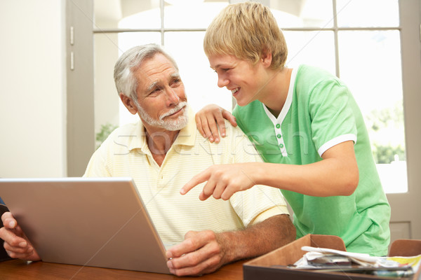 Adolescent petit-fils aider grand-père portable maison [[stock_photo]] © monkey_business