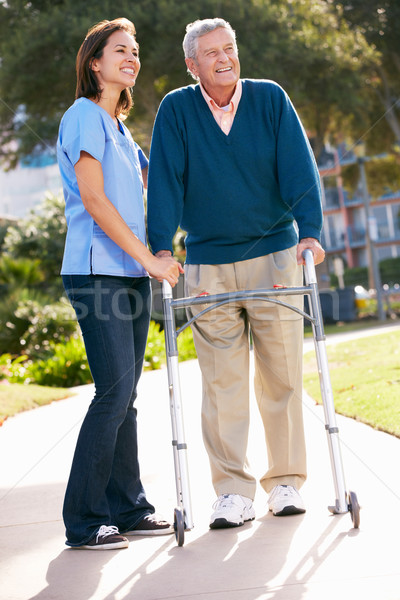 Carer Helping Senior Man With Walking Frame Stock photo © monkey_business