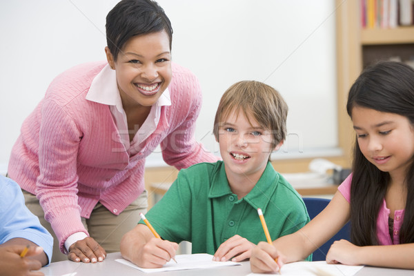Teacher and pupil in elementary school classroom Stock photo © monkey_business