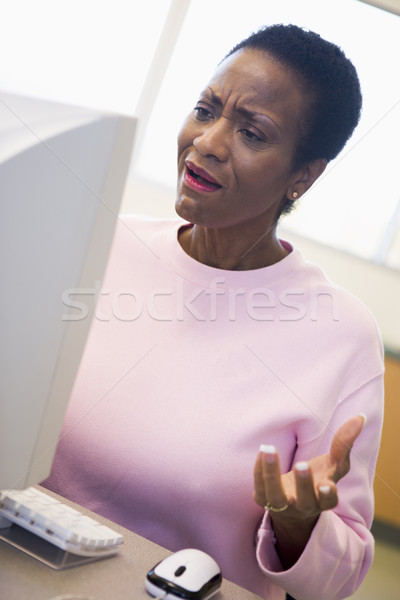 Mature female student expressing frustration at computer Stock photo © monkey_business