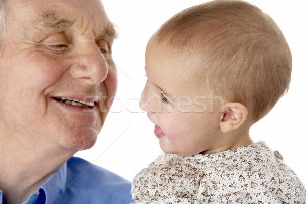 Stock photo: Portrait of grandfather and granddaughter, smiling at each other