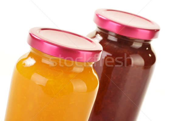 Two jars of fruity jams isolated on white. Preserved fruits Stock photo © monticelllo