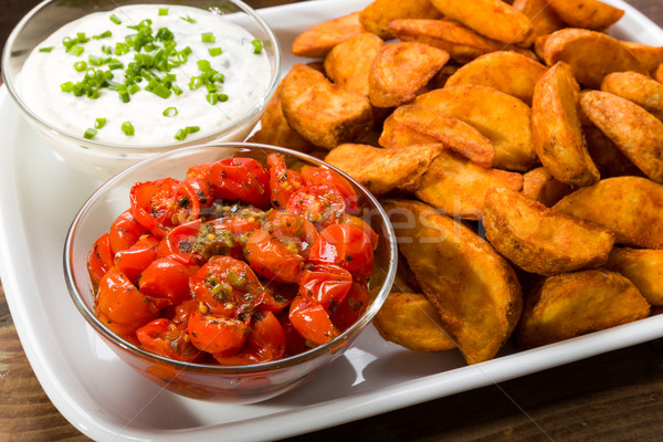Potato wedges with dip and roasted tomatoes Stock photo © Moradoheath