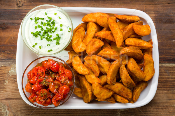 Potato wedges with dip and roasted tomatoes Stock photo © Moradoheath