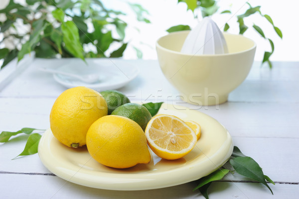 Citrus squeezer and fresh lemons being used to make fresh lemonade Stock photo © Moravska