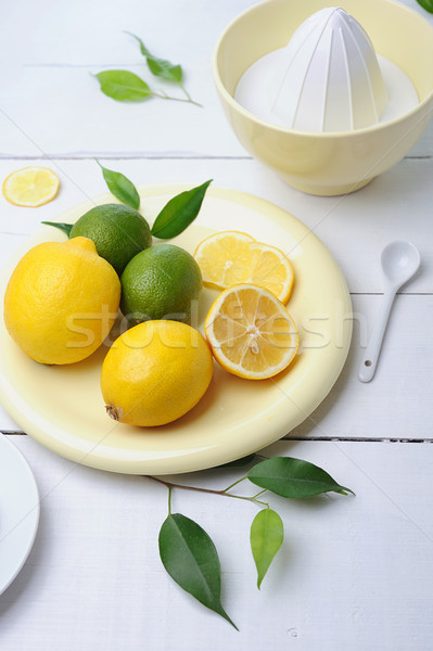 Citrus squeezer and fresh lemons being used to make fresh lemonade Stock photo © Moravska