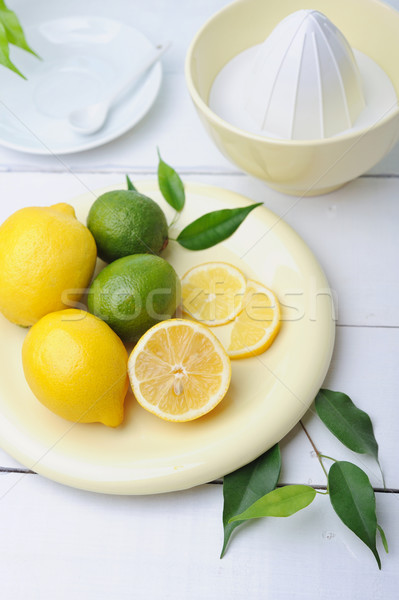 Citrus squeezer and fresh lemons being used to make fresh lemonade Stock photo © Moravska