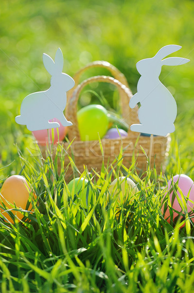 Coloured Easter Eggs In A Basket Padded Out With Rabbit Decorations Stock photo © Moravska