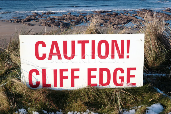 red caution sign on slippery cliff edge Stock photo © morrbyte