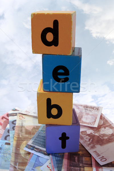 money debt in toy play block letters against clouds Stock photo © morrbyte