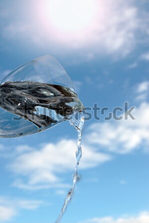 glass of water against a cloudy sky Stock photo © morrbyte